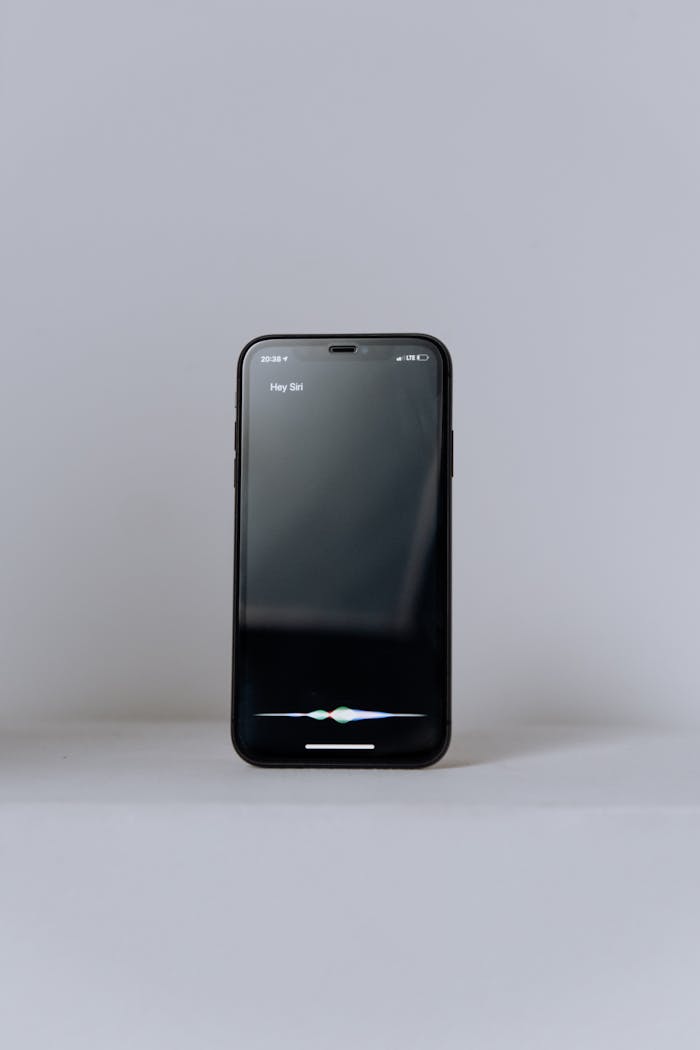 Minimalist photo of a smartphone displaying a virtual assistant on a neutral background.